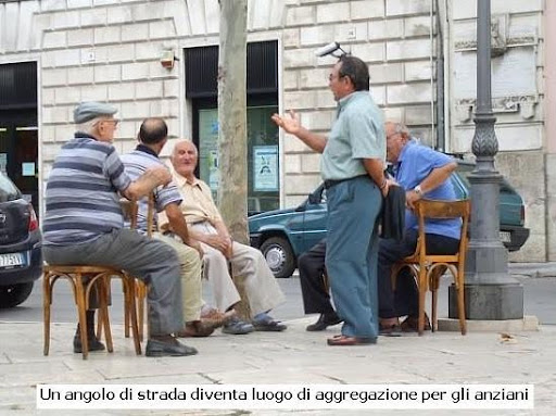 A street corner in Italy is a typical meeting place for elderly Italians